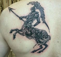 a man with a tattoo on his back riding a horse holding a bow and arrow