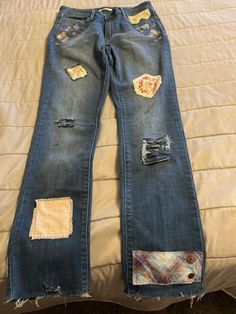 "Elevate your fashion game with these reworked Levi Mid Rise Skinny Jeans for Women in size 30\" X32\". These jeans feature a  floral embroidery around the front pockets and accents like crochet, lace, distressing, and patches adding a touch of bohemian and peasant style to your wardrobe. The closure features both a zip and button, while the pocket type is a classic 5-pocket design. The hand reworked distressed details, appliques and embroidery make them uniquely stylish. They come with a 32-inch inseam and a mid-rise of 8.5-10.5 inches. These hand embellished reworked jeans are perfect for the hipster, hippie, and fun-loving fashionista. Each piece of reworked denim I make is a one-of-a-kind piece of fashion & fabric art.  No one will have a duplicate...it will be unique to you!" Reworked Jeans, Reworked Denim, Peasant Style, Fashion Fabric, Mid Rise, Fashion Games, Women Jeans, Wardrobe, Embroidery