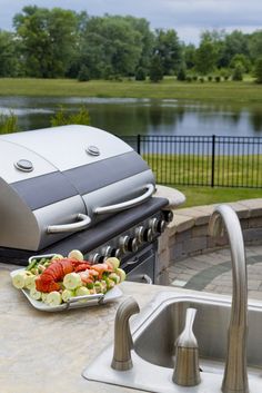 a plate of food sitting on top of a counter next to a sink and grill