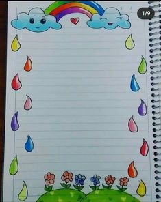 an open notebook with rain and rainbows on it