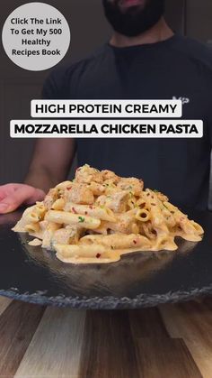 a man is holding a plate of food with the words high protein creamy mozzarella chicken pasta