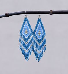 "These handmade earrings are made of high-quality Japanese and Czech beads and strong synthetic thread. They are elegant, fashionable, and suitable for any occasions.  Colors: turquoise, blue , white , grey Length: 4.2 inches (10.8 cm) Width: 0.1 inches (2.7 cm) Materials:     Japanese Miyuki seed beads      Czech \"Preciosa\" beads     Durable synthetic thread     925 Sterling silver ear hooks  Please note Real colour may slightly differ from one monitor to another, as it depends on specific mo Bohemian Handmade Light Blue Earrings, Handmade Turquoise Tassel Earrings For Festival, Blue Dangle Tassel Earrings As Gift, Turquoise Handmade Tassel Earrings For Festivals, Blue Dangle Tassel Earrings For Gift, Blue Tassel Drop Earrings For Festival, Handmade Light Blue Dangle Earrings, Blue Tassel Drop Earrings For Gift, Handmade Light Blue Dangle Jewelry