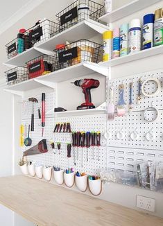 a workbench with lots of crafting supplies on it's walls and shelves