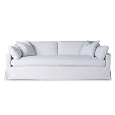 a white couch with two pillows on it's back and one arm folded up