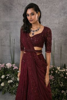 Rosewood organza silk lehenga with thread, sequins, cutdana, and crystals embroidery. Comes with a net blouse, a dupatta, and a belt.
Component: 4
Pattern: Embroidered
Type Of Work: Thread, Sequins, Cutdana, Crystals
Neckline: V Neck
Sleeve Type: Half
Fabric: Lehenga : Organza silk, Blouse and Dupatta : Net, Lining : Shantoon
Color: Maroon
Other Details: 
Closure : Zip on the side for lehenga and hooks at the back for blouse.
Occasion: Wedding, Bride - Aza Fashions Organza Pre-draped Saree With Unstitched Blouse, Anarkali Style Pre-draped Organza Saree For Eid, Festive Raw Silk Pre-draped Saree For Reception, Designer Organza Pre-draped Saree With Dori Work, Traditional Organza Pre-draped Saree For Party, Festive Floor-length Blouse Piece For Reception, Raw Silk Pre-draped Saree With Sheer Dupatta For Reception, Anarkali Pre-draped Raw Silk Party Saree, Bollywood Style Pre-draped Tissue Silk Saree For Reception