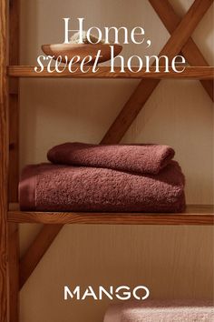 two shelves with towels on them and the words home, sweet home in white letters