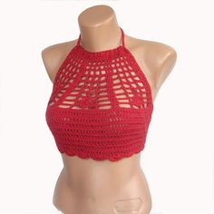 a female mannequin wearing a red crochet halter top with cut outs