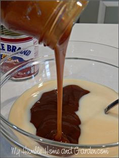 chocolate sauce being poured into a glass bowl