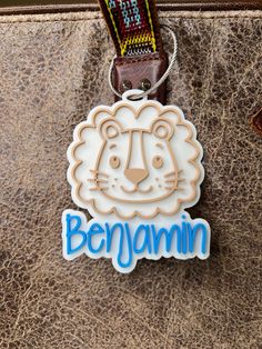 "Looking for an adorable way to customize your bag.  Our 3D printed customized Lion name tag comes with a white background with your choice of name color.   Please see list of filament color choices in the photos.   The lion is printed in Matte Latte color.  If you want a different color, please specify in personalization field.   Size of Lion Tag is approx 3.75\" x 3\"  Ordering Procedure: 1. Select Name Color 2. Select silver wire keychain or plastic strap This item is 3D Printed with the high Novelty White School Bag, White Novelty School Bags, Personalized White Luggage Tag, Personalized White Rectangular Luggage Tag, Customizable White Luggage Tag For Gift, Customizable White Luggage Tag Gift, White Bag With Custom Name For Personal Use, White Bags With Custom Name For Personal Use, Customizable White Luggage Tag For Travel