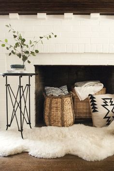 the instagram page for instagram com features an image of a fireplace with baskets and blankets on it