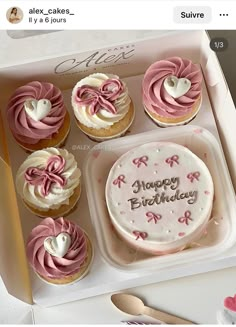 a box filled with lots of cupcakes covered in pink frosting and hearts