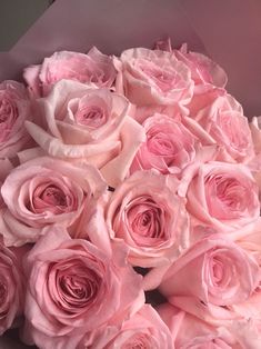 a bouquet of pink roses in a white box