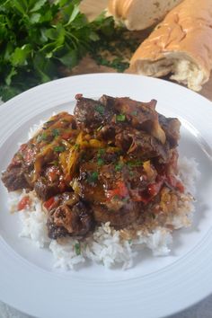 a white plate topped with meat and rice