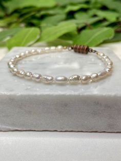 This fresh water pearl bracelet is a beautiful accessory to any outfit and is perfect for stacking. The magnet clip makes it easiest of all to put on. No struggling with the clasp. These vintage fresh water pearls are small in stature but will be big to your heart. They make a lovely, dainty bracelet.  Vintage, fresh water pearl bracelet is paired with an antique bronze magnetic clasp.  All my creations are gift wrapped for delivery. Fresh Water Pearl Bracelet, Ladies Gifts, Birthstone Bracelet, Bracelet Dainty, Dainty Bracelet, Freshwater Pearl Bracelet, Fresh Water Pearls, Birthstone Bracelets, Fresh Water Pearl