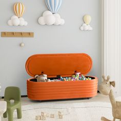 an orange storage box filled with toys in a child's room