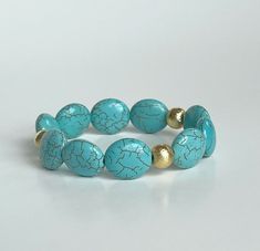 The Trailblazer Turquoise bracelet is cowgirl chic and absolutely beautiful in person! The 14k gold brushed beads add a touch of glam to a classic western piece! These chunky turquoise magnesite beads are a great size to stack together or with your existing turquoise! ⭐️Looking for other turquoise and western inspired looks? Dolly Acrylic and Turquoise Stack ---> https://etsy.me/3HbWBqE Lone Star Stacker ---> https://etsy.me/34NmUX2 Bracelets are handmade on strong stretch cord and approximately Trendy Hand-strung Turquoise Jewelry, Elegant Turquoise Stretch Bracelet As A Gift, Elegant Turquoise Stretch Bracelet As Gift, Elegant Turquoise Stretch Bracelet With Natural Stones, Elegant Handmade Turquoise Stretch Bracelet, Elegant Turquoise Beaded Stretch Bracelet, Western Bracelets, Cowgirl Chic, Arm Party