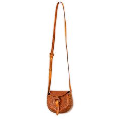 A beautiful, handcrafted, hand-stamped leather handbag. Traditional styling, and heirloom quality leather-tooling and finishing is evident in every piece. About 5" tall x 7" across x 3" deep. Leather closure. Adjustable cross-over strap, 44'' - 55''. Handmade in Mexico. Artisan Hand Tooled Crossbody Saddle Bag, Traditional Leather Satchel With Adjustable Strap, Artisan Hand Tooled Crossbody Satchel, Traditional Leather Saddle Bag With Adjustable Strap, Artisan Hand-tooled Crossbody Satchel, Traditional Leather Saddle Bag For Everyday Use, Traditional Leather Crossbody Satchel, Traditional Brown Leather Saddle Bag, Traditional Leather Shoulder Bag With Embossed Detail