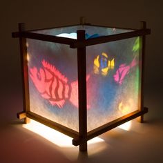 a light that is inside of a box with some fish on it's sides