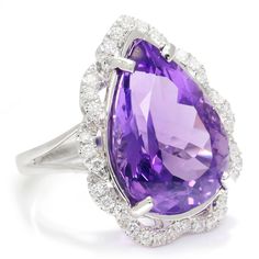 Description: The amethyst has long been thought to symbolize peace, balance and inner strength. This bold and exquisite example of this gem weighs 9.16-carats, is teardrop in shape and sleeps in a bed of diamonds. The pear mixed cut is a treasure chest of facets that exhibit varying shades of light to dark violet hues which are enhanced by the sparkle and fire of the accent diamonds. The solid 18kt white gold ring setting is a perfect celebration piece for this gem. It is a size 6.75 and is Bran Luxury Teardrop Gemstones, Elegant Purple Teardrop Gemstone, Luxury Purple Teardrop Jewelry, Elegant Teardrop Amethyst Ring, Luxury Purple Drop Jewelry, Formal Teardrop Amethyst Ring In Fine Jewelry Style, Elegant Teardrop Amethyst Gemstone Ring, Elegant Teardrop Amethyst Ring For Formal Occasions, Elegant Teardrop Purple Amethyst Ring