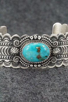 This stunning Kingman turquoise and sterling silver bracelet featuring a scalloped edge cuff was made by Navajo silversmith Michael Calladitto. The inside is signed M&R Calladitto and stamped Sterling.Size: 5 3/4" (will fit up to a 7 1/8" wrist)Gap: 1 3/8"Width: 1"Free shipping on all orders! We ship with USPS and always include tracking. All orders ship within a day of payment.Returns are accepted up to 30 days after you receive your order. Just send us a message. Our shop offers cash back or s Etched Turquoise Sterling Silver Jewelry, Western Style Bangle Jewelry Gift, Western Style Bangle Jewelry As Gift, Western Style Bangle As Gift, Artisan Turquoise Engraved Bracelets, Artisan Turquoise Engraved Bracelet, Southwestern Etched Turquoise Jewelry, Southwestern Style Etched Turquoise Jewelry, Southwestern Turquoise Etched Jewelry