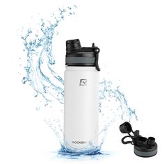 a white water bottle next to a black and gray object with water splashing on it