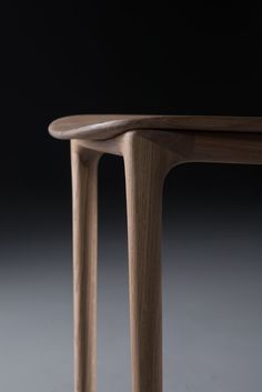 a wooden table sitting on top of a gray floor