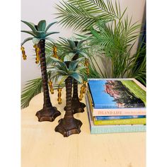 two palm trees are sitting next to some books