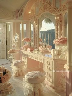 an ornately decorated dressing room with pink flowers on the vanity and large mirror above it