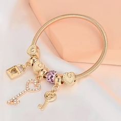 Trendy Rhinestone Spring Bracelet Bangle Rhinestones Accentuate Details - Specifically The Key Golden Color Key Lock Pendant Bracelet One Accent Charm With Lavender Faux Stones Size Is Shown In The Last Picture #Bx7-545 Gold Crystal Heart Bracelets, Gold Heart Crystal Bracelets, Gold Heart-shaped Crystal Bracelets, Cotton Dress Indian, Golden Bracelet, Lock Pendant, Color Key, Spring Bracelet, Dress Indian