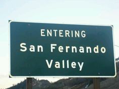 a green and white sign that says entering san fenando valley