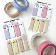 several rolls of washi tape are on the table next to some bunny stickers