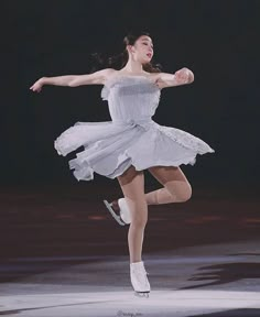 a woman in a white dress is dancing