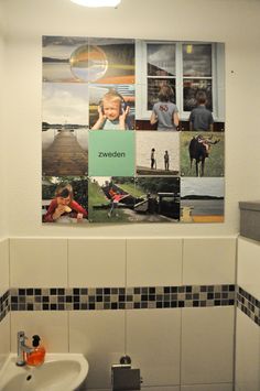 a bathroom with pictures on the wall and a sink