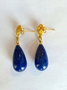 These gorgeous large drop earrings feature big Denim Blue Dumorterite teardrops which dangle playfully on a fancy filigree 24K vermeil post.  These drop measure 23 x 12 mm and dangle about 1 3/4" inches. They are fabulous everyday fun funky ear drops  Check out all of the amazing Gemstones Earrings at PorcelainIndustry? Click:  http://www.etsy.com/shop/PorcelainIndustry?section_id=12154859  Looking for a Multi Gemstone Necklace instead, click:  http://www.etsy.com/shop/PorcelainIndustry?section_id=12161020  These earrings are perfect to bringhten up the winter months or for that speical trip to the sunshine.   Your earrings will arrive tastefully presented in a gift box and come with their own pouch to keep them safe those rare times when you don't want to wear them. Blue Dangle Teardrop Earrings, Blue Gemstone Teardrop Earrings, Blue Briolette Teardrop Earrings For Gift, Blue Drop Earrings Pierced, Handmade Yellow Gold Teardrop Earrings, Blue Teardrop Earrings, Large Drop Earrings, Multi Gemstone Necklace, Ear Drops