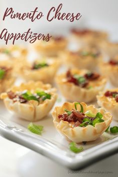 small appetizers are arranged on a white platter