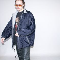 "Vintage 90s warm windbreaker jacket in navy blue   Size on tag : L, Approx. size : L/XL, Length : 81 cm / 32\", Armpit to armpit : 66 cm / 26\", Sleeve : 53 cm / 21\". Material :, Nylon, Polyester, Lining : Polyester.   Model Height : 183 cm / 6'0\"" Urban Navy Outerwear For Streetwear, Oversized 90s Hooded Outerwear, Urban Navy Windbreaker For Outdoor, Navy Nylon Windbreaker For Winter, Navy Urban Windbreaker For Outdoor, Navy Nylon Winter Windbreaker, 90s Style Windbreaker For Winter Streetwear, 90s Style Winter Windbreaker For Streetwear, Navy Windproof Windbreaker For Winter