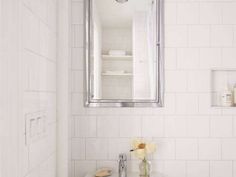 a bathroom sink with a mirror above it next to a white toilet and counter top