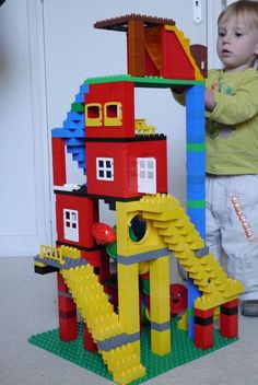 a little boy playing with some legos on the floor