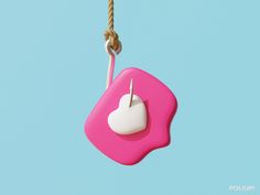 a pink and white object hanging from a rope