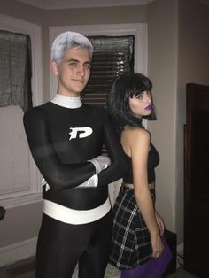 two people dressed up in black and white outfits, one is holding his arm around the other