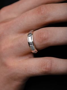 a woman's hand with a wedding ring on it