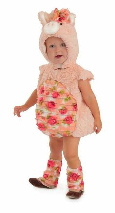 a baby girl wearing a pink dress and boots