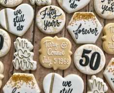 decorated cookies are arranged on a table for someone's 50th anniversary celebration, with the date 50 years ago