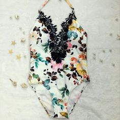 This Sexy, Gorgeous Halter Monokini Has A Deep Plunge Neckline & Is Decorated With Black Lace. It Has Golden Beads On The Neck Ties, Built In Padding & Is Double Layered. It Is White With Teal, Orange & Pink Floral Pattern. The Panty Line Is Cheeky At The Butt. Length For Extra Small: 20.5" Length For Small: 22" 20% Off Your Entire Purchase When You Bundle With Any Other Item(S)! White V-neck Tankini For Summer, White V-neck Summer Tankini, Floral Print Beachwear Swimwear For Party, Floral Print Party Swimwear, Chic Stretch Swimwear With Floral Print, White Backless Tankini For Vacation, Floral Print Beachwear For Party, White Backless Tankini For Summer, White Backless Summer Tankini