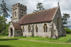 an old stone church in the middle of a field