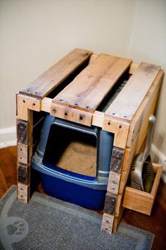 an old tv sitting on top of a wooden pallet next to a trash can