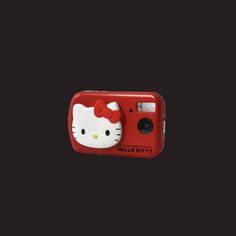 a red hello kitty camera on a black background