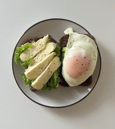 an egg and lettuce breakfast sandwich on toast