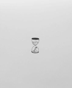 an hourglass sitting on top of a white surface