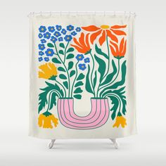 a shower curtain with flowers and plants in it